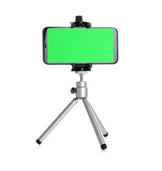 Smartphone with green screen fixed to tripod on white background. Mockup for design
