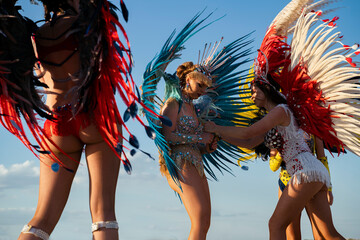 Samba dancers before carnival, adjusting costumes 