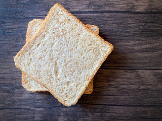 Wheat bread ready to eat on the wooden background