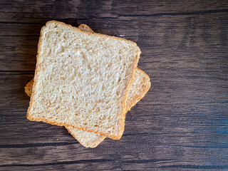 Wheat bread ready to eat on the wooden background