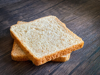 Wheat bread ready to eat on the wooden background