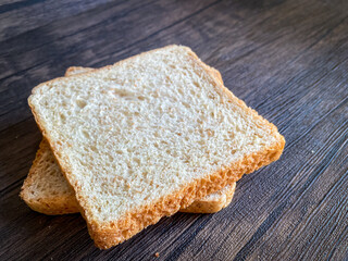 Wheat bread ready to eat on the wooden background
