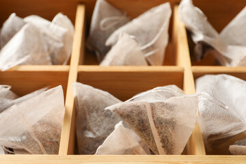 Fototapeta na wymiar Paper tea bags in wooden box, closeup