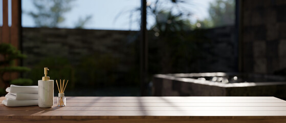 Copy space on wood tabletop over blurred background of outdoor Onsen bath.