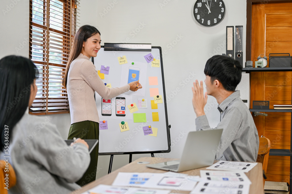 Poster female designer presenting her mobile application's interface prototype to a developer team