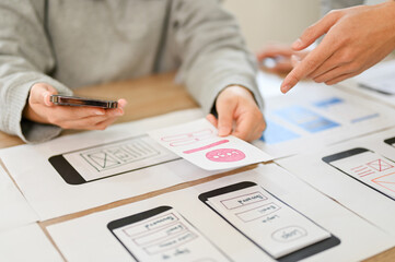 A team of mobile application interface designers are in the meeting. cropped image