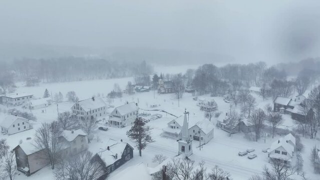 Flight over snow-covered Monson Town towards frozen Lake