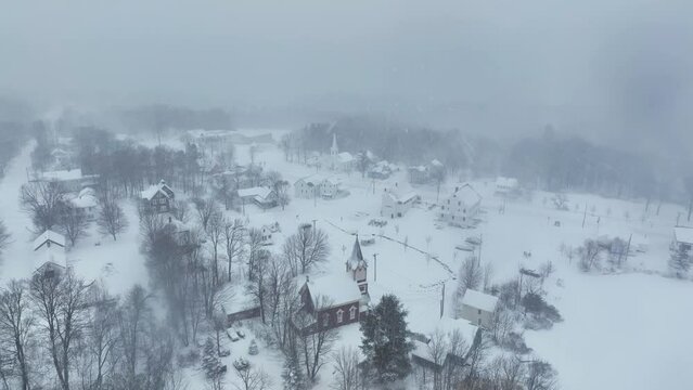 Aerial flight over the two churches of Snow covered Monson