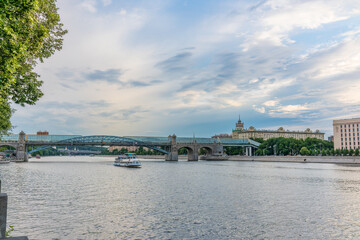 Obraz premium View of the Moscow river embakment, Pushkinsky bridge and cruise ships at sunset.