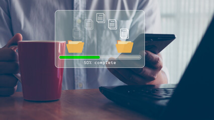 Data transfer concept. Copy files, data exchange, Files transfer. Person hand using mobile smart phone and laptop computer waiting for transfer file process with loading bar icon on virtual screen.
