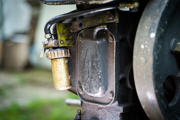 Chinese fuel filter on a walk-behind tractor close-up on a blurred background