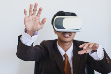 Close-up of businessman in suit using VR glasses and gesturing hands.