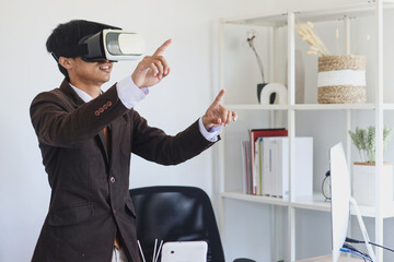 Businessman in suit using virtual reality glasses and headset is gesturing hands as if touching at the office