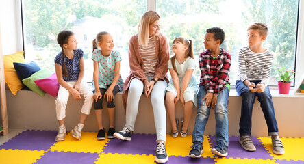 Cute little children with teacher in primary school