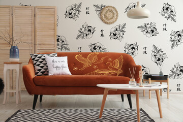 Light interior of living room with stylish sofa and beautiful Asian print on wall
