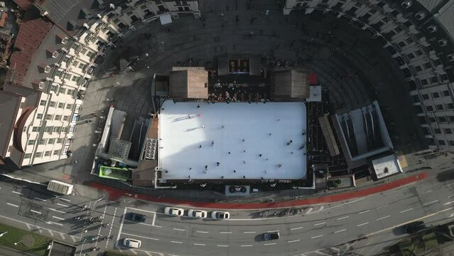 People having fun at Stachus Karlsplatz, Munich, Christmas ice Skating Rink, High quality Arial 4k footage