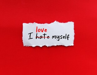 Torn paper on red background with handwritten I HATE MYSELF,  replaced with I LOVE MYSELF, concept...