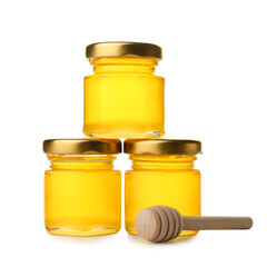 Tasty honey in jars and dipper on white background