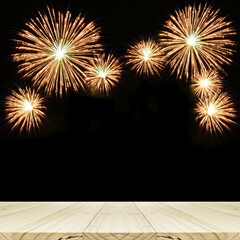 Background of wood table with fireworks backdrop.