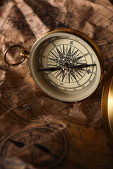Fototapeta na wymiar Golden compass on world map, closeup