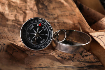 Fototapeta na wymiar Small compasses on world map
