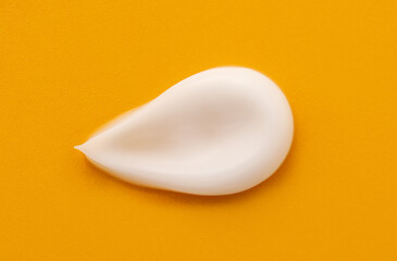 Sample of moisturizing cream on yellow background