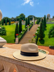 Wicker hat on marble fence in beautiful park