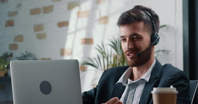 Close-up shooting, male mentor video chats with colleague and shares his professional experience to increase their career growth. Successful man with beard communicates online with work colleague