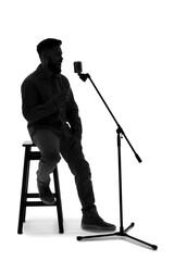 Silhouette of male singer with microphone on white background