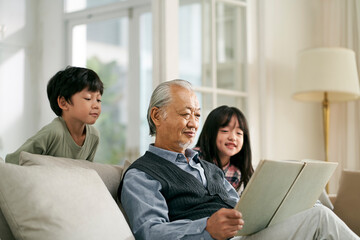 asian grandpa having a good time with grandchildren