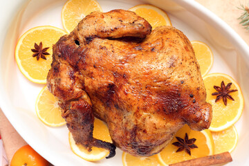 Baking dish with tasty Christmas chicken and orange slices, closeup