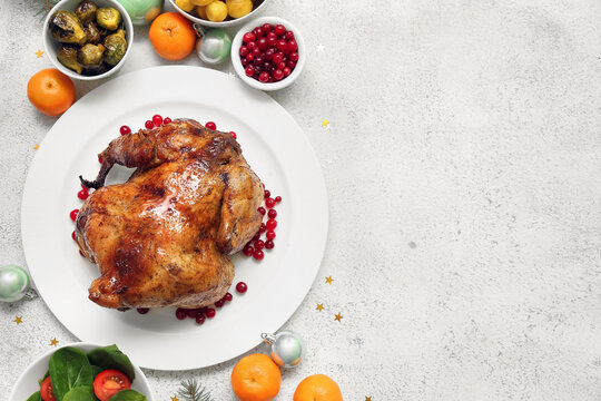 Tasty dishes for Christmas dinner on light background