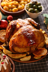 Plate with tasty chicken and potato on Christmas dining table in room, closeup