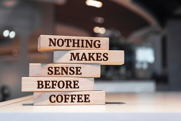 Wooden blocks with words 'Nothing makes sense before coffee'.