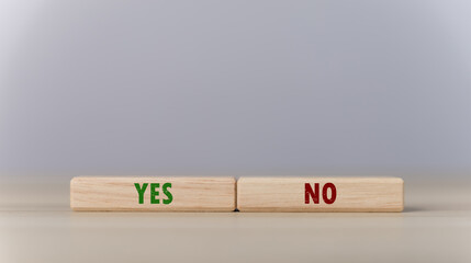 The wooden block shows yes or no letters.