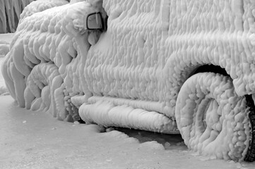 Severe winter, frozen car trapped in ice, Versoix, canton of Geneva, Lake Geneva shore, Switzerland, Europe, water blown from the lake by very strong wind at very low temperature frozing immediately