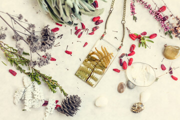 Close up pendant with fern leaves and floral elements concept photo. Top view photography with...