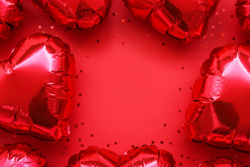 Frame made of heart-shaped balloons on red background. Valentine's Day celebration