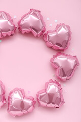 Frame made of heart-shaped balloons on pink background. Valentine's Day celebration