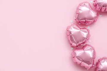 Heart-shaped balloons on pink background. Valentine's Day celebration