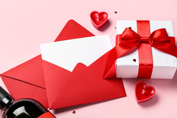 Envelopes with gift and candles on pink background. Valentine's Day celebration