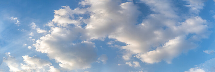 Blue sky and white clouds floated in the sky on a clear day with warm sunshine combined with cool breeze blowing against