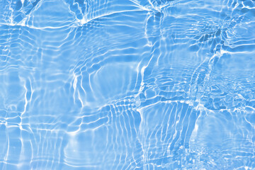 Defocus blurred transparent blue colored clear calm water surface texture with splashes and...