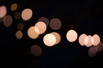 Bright bokeh of lights, blurred night background. New Year celebration.