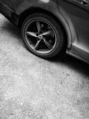 Close up of car wheel. Grunge art for design interior with black and white sport car. Painting on...