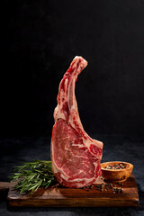 Raw Tomahawk beef steak and spices