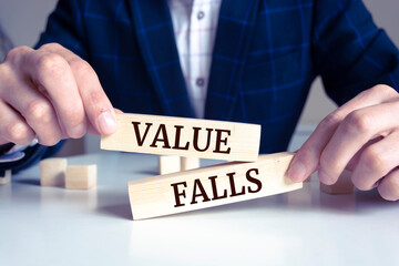 Wooden blocks with words 'Value falls'. Business concept