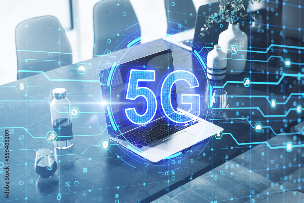 Poster close up of workplace with laptop with glowing 5g hologram on blurry background. 5g network concept,