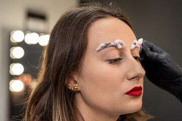 lashmaker applied eyebrow lamination foam to the client's eyebrows.