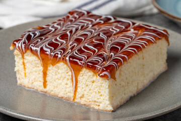Trilece cake slice on dark background. Milk and caramel cake. Bakery products. Mexican sweets....